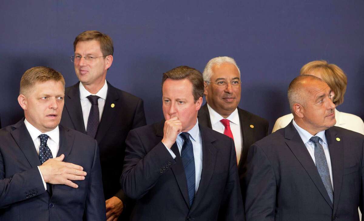 British Prime Minister David Cameron, center, waits for the start of a group photo at an EU summit in Brussels on Tuesday, June 28, 2016. EU heads of state and government meet Tuesday and Wednesday in Brussels for the first time since Britain voted to leave the European Union, throwing British and European politics into disarray. (AP Photo/Geoffroy Van der Hasselt)