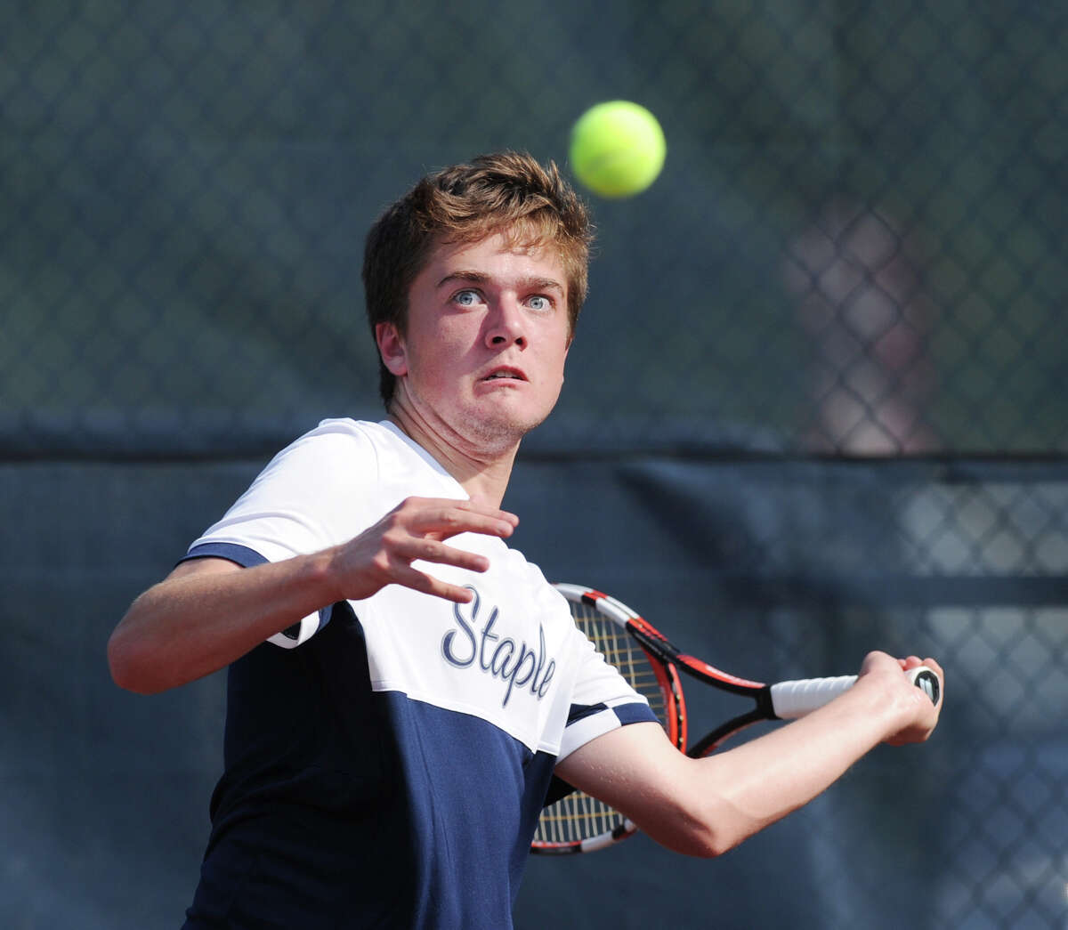William Andrews of Staples hits during the match he lost to William Blumberg of Greenwich during the FCIAC boys high school championship tennis match between Greenwich High School and Staples High School at Wilton High School, Conn., Wednesday, May 25, 2016. Staples beat Greenwich 4-3 to take the championship.