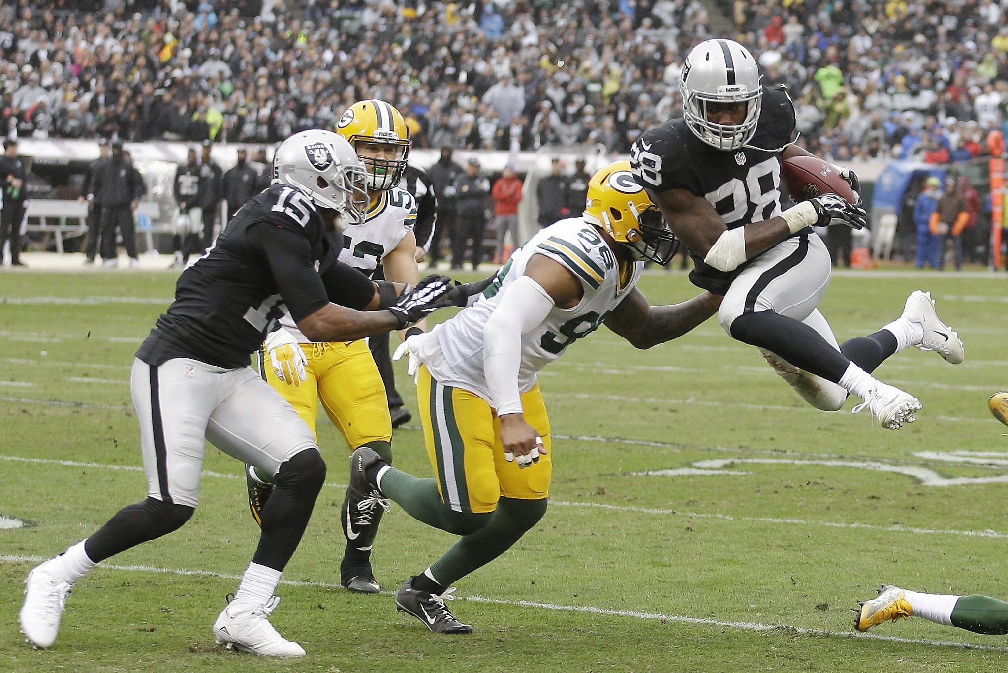 Oakland Raiders quarterback Derek Carr (4) and head coach Jack Del Rio  watch a replay during the second half of an NFL football game against the  San Diego Chargers in Oakland, Calif.