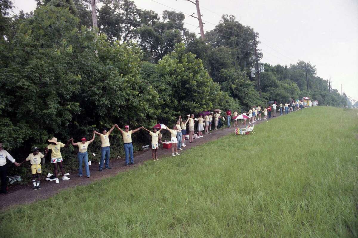 Houstonians take part in Hands Around Houston off Loop 610. The event was organized to help alleviate hunger in the city, June 22, 1986.