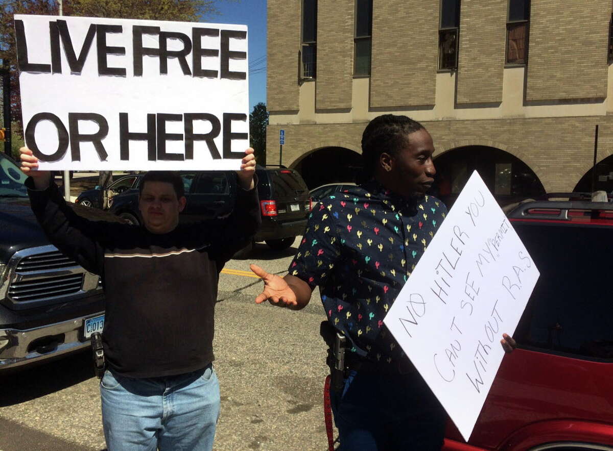 Dontrell Brown, right, is shown protesting in April outside the Bridgeport Police Department. Brown was arrested on Thursday, June 30, when police said he tried to bring loaded weapons into the Golden Hill Street courthouse.