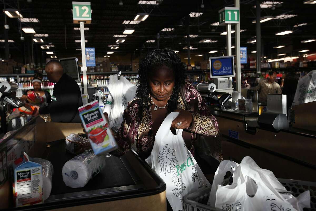 Kathy Chambliss of Oakland bags up her groceries in Foods Co Nov. 14, 2014 in Oakland, Calif. Chambliss says she uses plastic bags when she forgets her reusable bags.