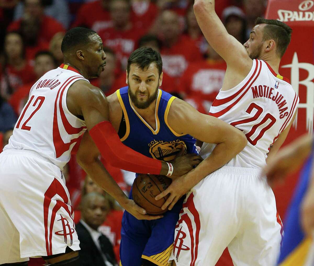 Dwight Howard, left, and Donatas Motiejunas had Warriors center Andrew Bogut sandwiched in the playoffs. But it doesn't look likely Howard will remain a Rockets teammate with Motiejunas next season.