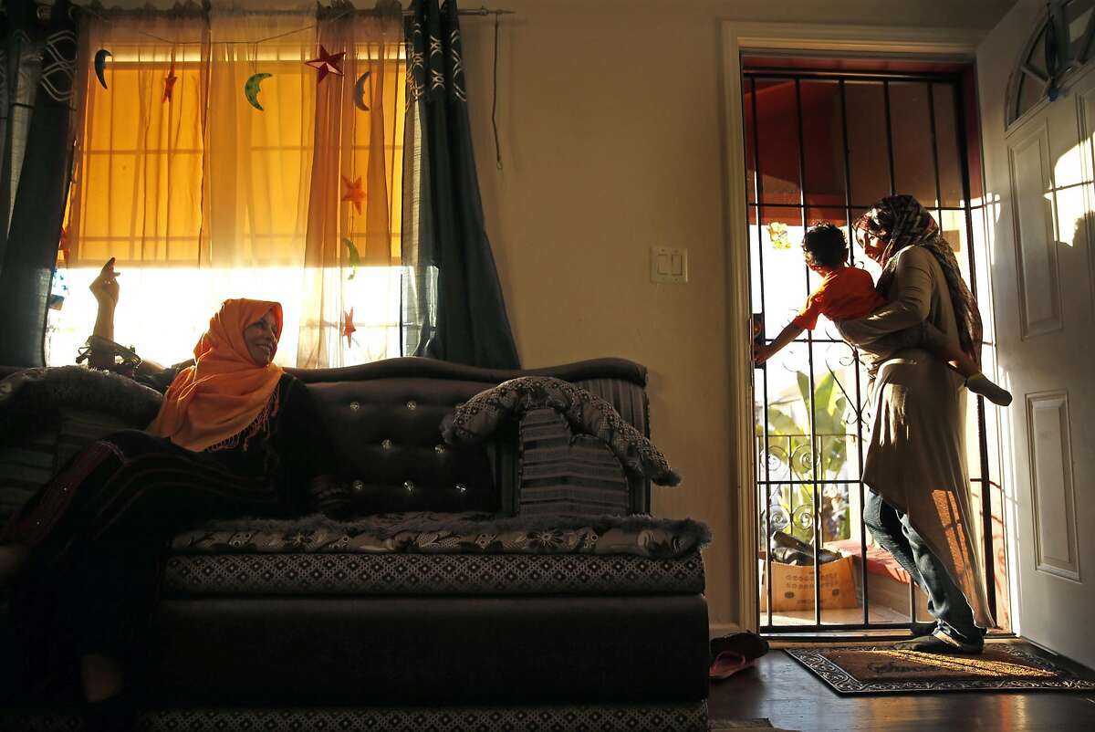 Shukria Hakim (left) watches as her daughter, Jehan Hakim, holds her grandson, Ismael Bafakih, 18 months, as they wait to break their Ramadan fast in San Leandro, Calif., on Thursday, June 30, 2016.