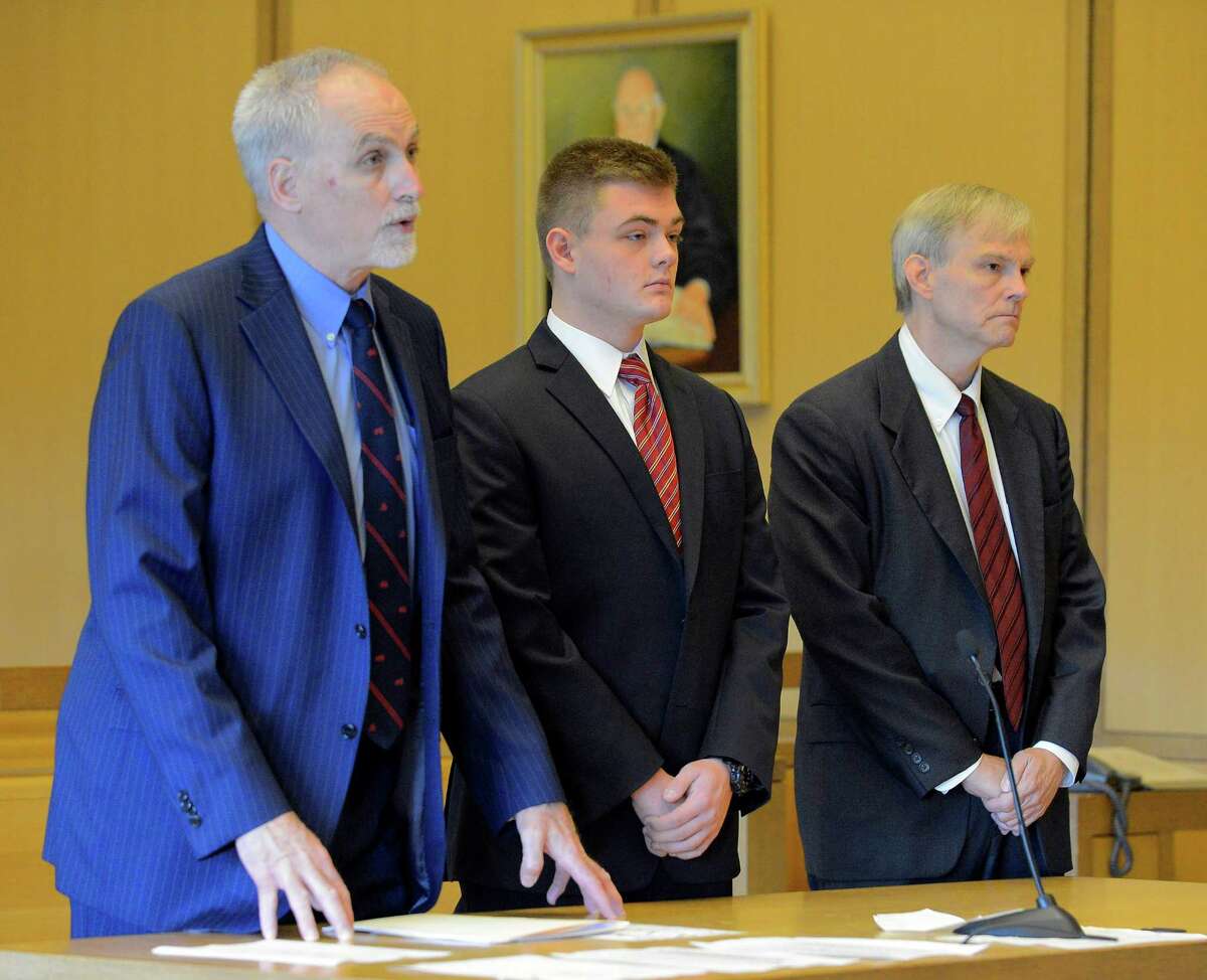 Andrew Schmidt, center, stands with his attorney Eugene Riccio, left, and father James Schmidt, at right, at Connecticut Superior Court in Stamford, Conn. on July 1, 2016 during a hearing to consider a motion to transfer his case to juvenile court. Schmidt is charged with evading responsibility in an accident that results in a fatality, a felony punishable by up to 10 years in prison, in connection with the hit-and-run collision that killed Edward Setterberg on April 17.