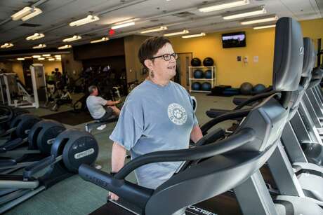 Linda Guinee, a survivor of breast cancer who was part of a weight loss clinical trial, exercises at a gym in Boston, June 24, 2016. Scientists are recruiting thousands of women for a large clinical trial to find out if weight loss should be prescribed as a treatment for breast cancer.