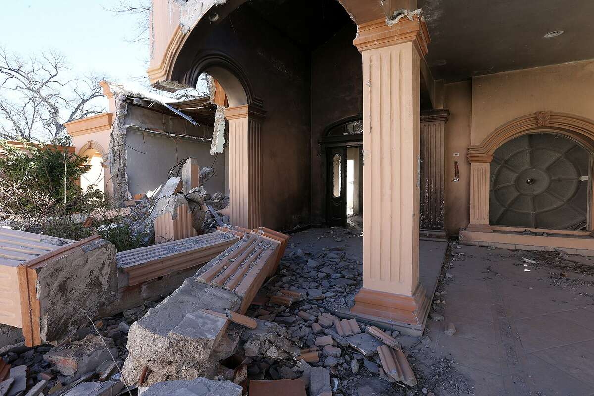 A burned-out house lies in ruins in the the town of Allende, Mexico, Tuesday, Jan. 27, 2015. Allende is a small town west of Piedras Negras, Mexico and is the site of a massacre by the drug cartel, Los Zetas. It is estimated that over 300 went missing or killed in March of 2011. Over 25,000 are considered missing in Mexico through the end of 2014.