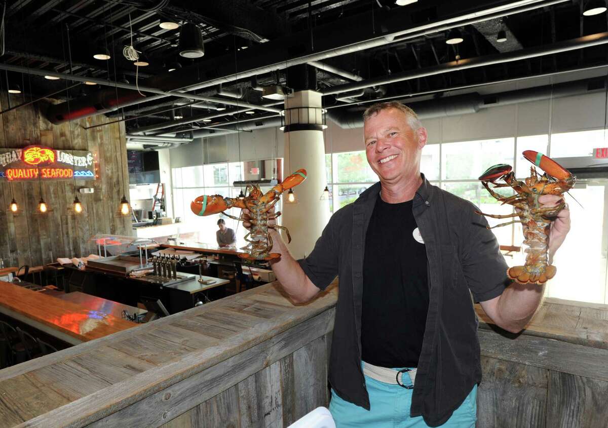 Boothbay Lobster Company co-owner David Galin with two Boothbay lobsters in his restaurant and bar that will be opening soon at 14 Harbor Point Road in Stamford.