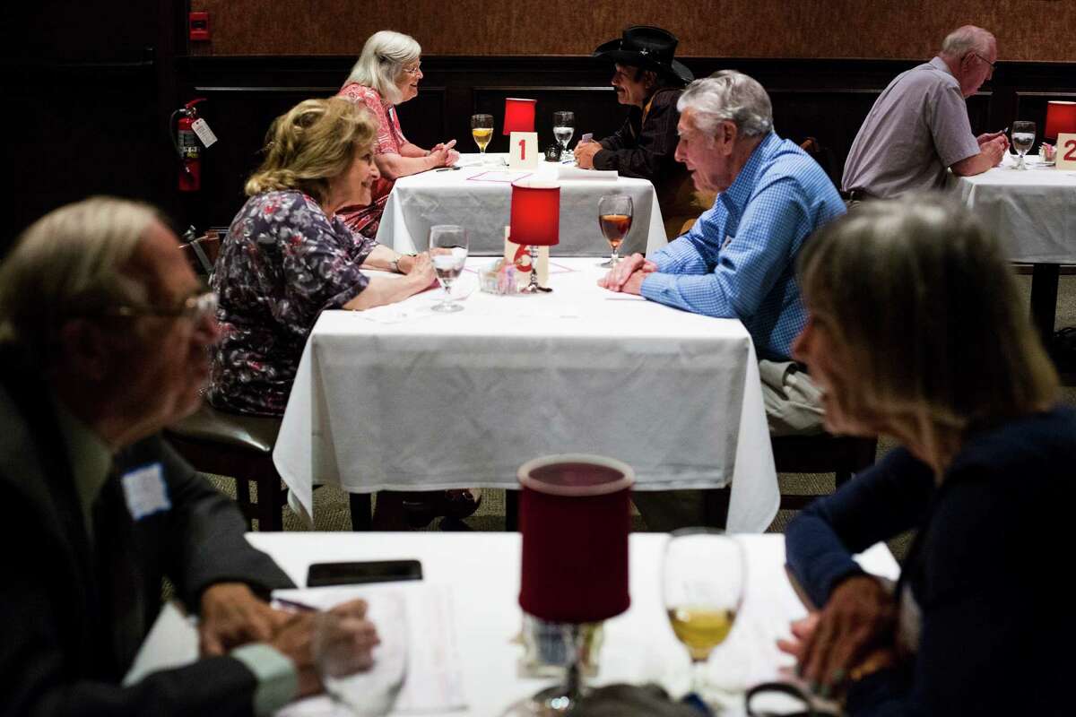 Participants hold conversations with their dates for just five minutes during a senior speed dating event at Bob's Chop and Steakhouse in San Antonio, on Wednesday, June 22, 2016.