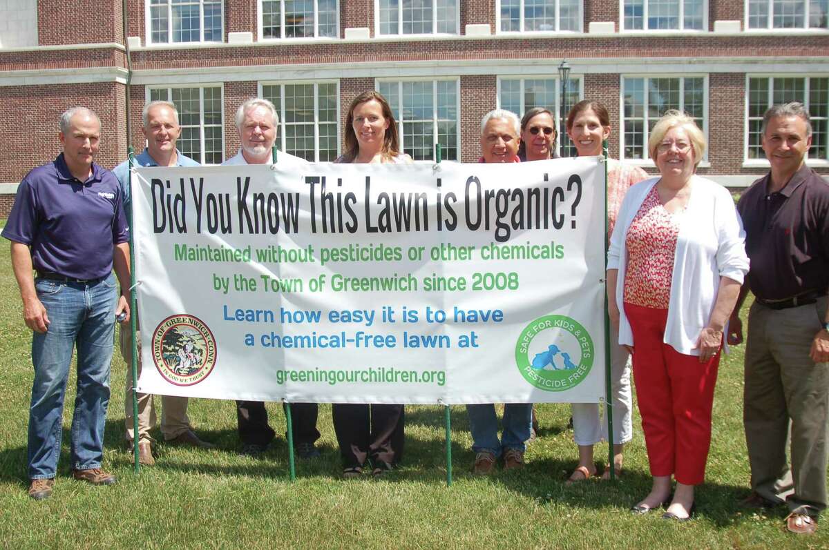 To show off the benefits of an organic lawn, a sign is up at Town Hall to advertise the Safe Lawns initiative. From left, Tim Coughlin, turf operations manager for the town, Darrin Wigglesworth, operations manager, Tree Warden Bruce Spaman, Aleksandra Moch from the conservation department, Parks and Recreation Director Joseph Siciliano, Safe Lawns co-founder Abby Levy, Consrervation Director Denise Savageau and State Rep. Fred Camillo all posed by the sign.