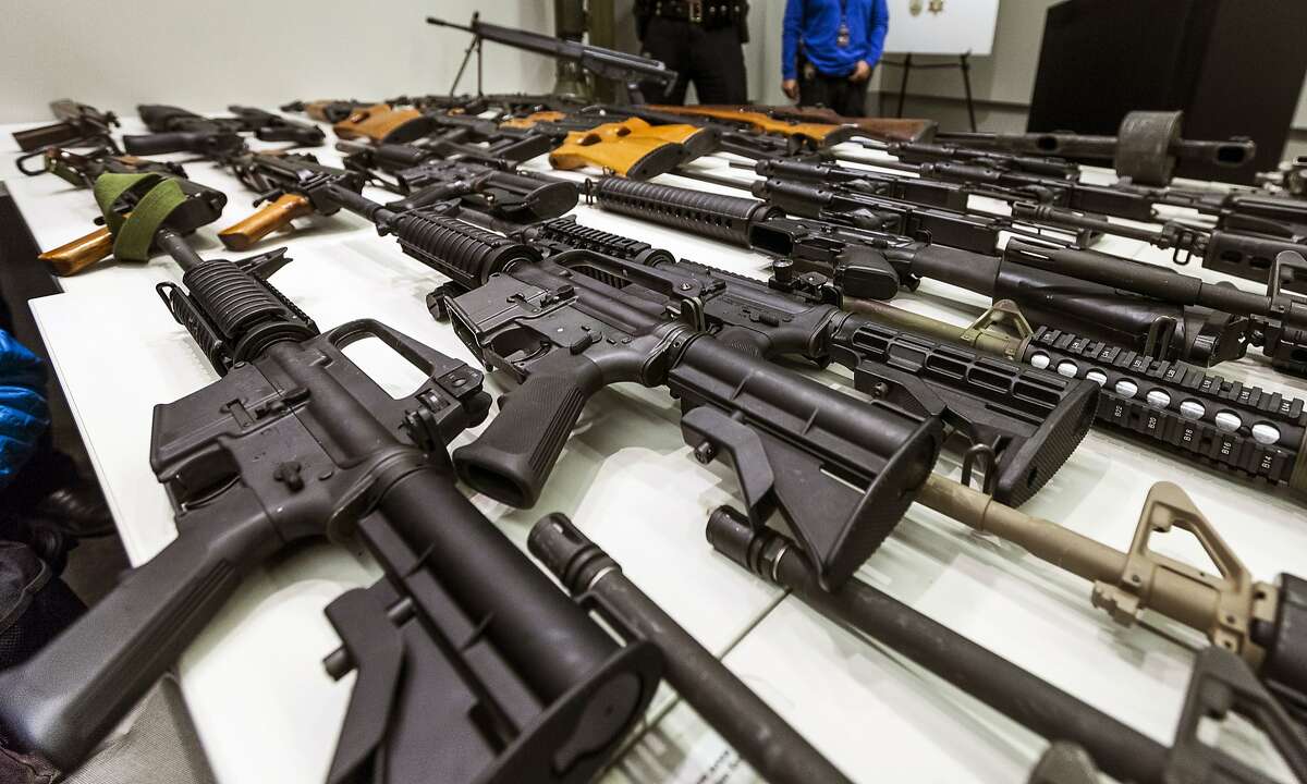 In this file photo a variety of military-style semi-automatic rifles obtained during a buy back program are displayed at Los Angeles police headquarters. Gov. Jerry Brown signed six stringent gun-control measures Friday, July 1, 2016, that will require people to turn in high-capacity magazines and require background checks for ammunition sales, as California Democrats seek to strengthen gun laws that are already among the strictest in the nation.