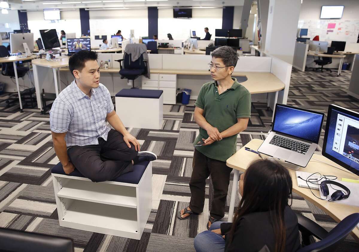 Product manager Thaya Kareeson (left), talks with software engineers Darin Zhou (middle), and Veronica Tan (bottom right) about photos on the sports app at Comcast/NBC on Wednesday, June 29, 2016, at the Comcast Silicon Valley Innovation Center in Sunnyvale, Calif.