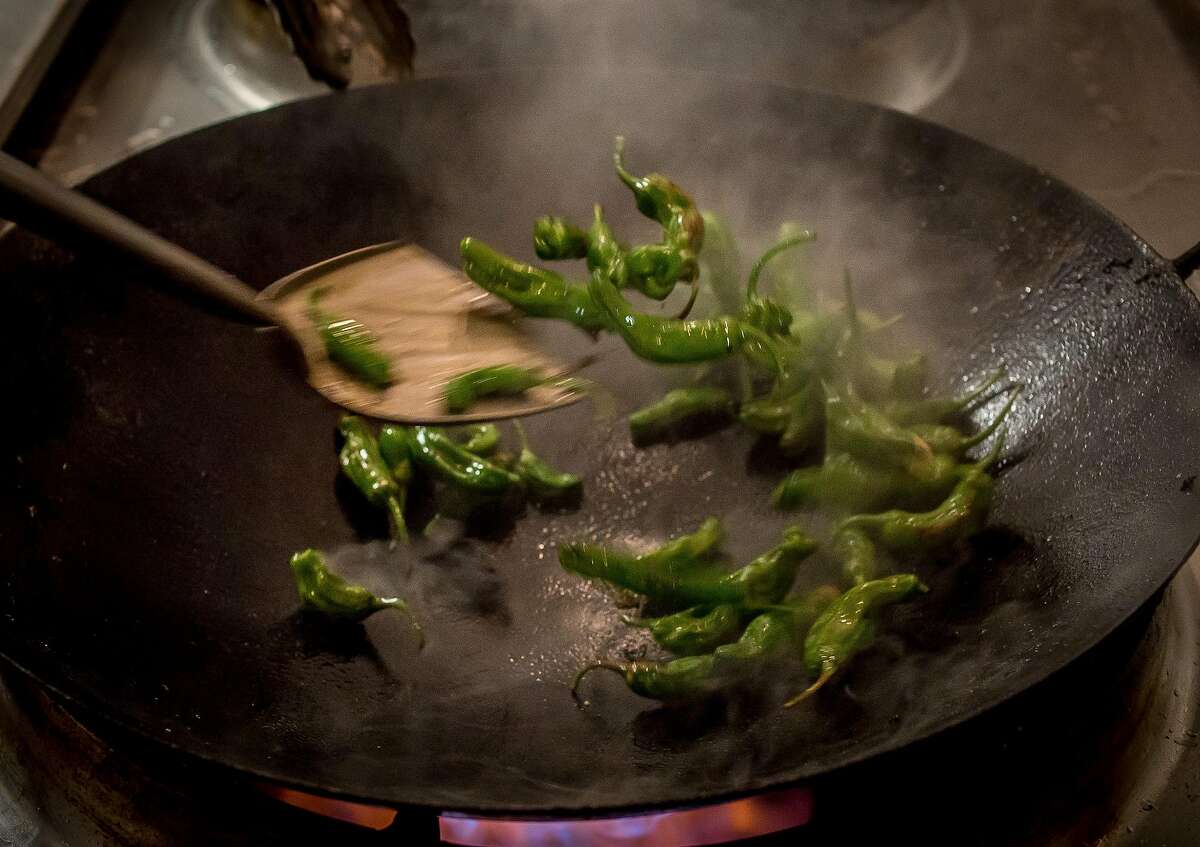Shishito peppers being cooked in a wok at Miminashi in Napa, Calif. are seen on June 30th, 2016.