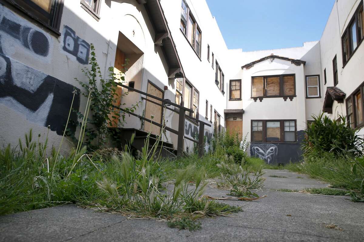 Weeds flourish in front of an abandoned apartment building on Durant Avenue in Berkeley, Calif. on Saturday, July 2, 2016. The city has approved the demolition of the building to make way for a five-story residential project, which has angered rent control advocates and some local residents.