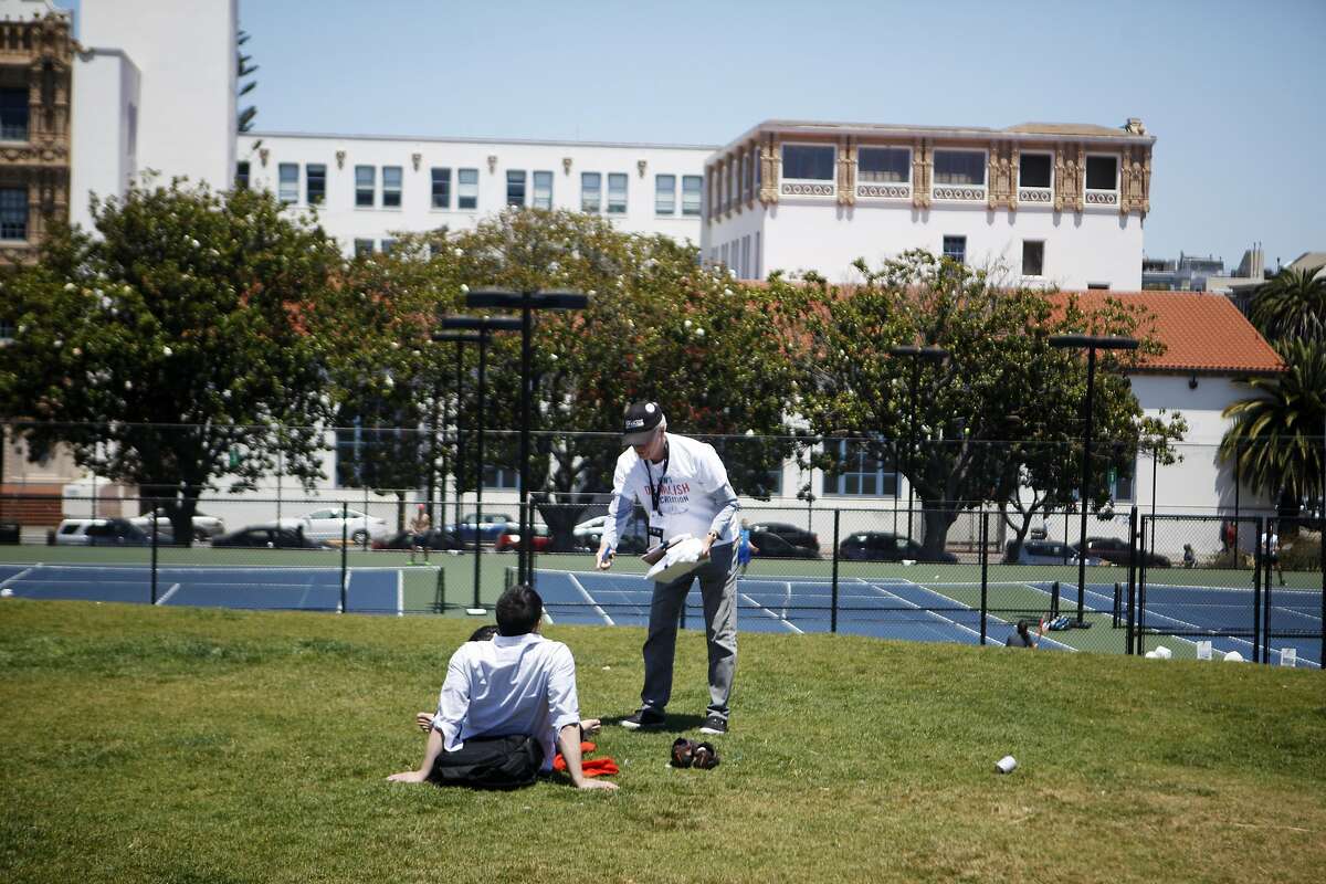 David Brenlinger of San Francisco speaks with park goers in hopes to get signatures on Saturday, July 2, 2016 at Mission Dolores Park in San Francisco, California. This ballot measure is looking to protect the San Francisco Tennis Club, which is slated to be replaced by office buildings, a smaller recreation facility, and some affordable housing.