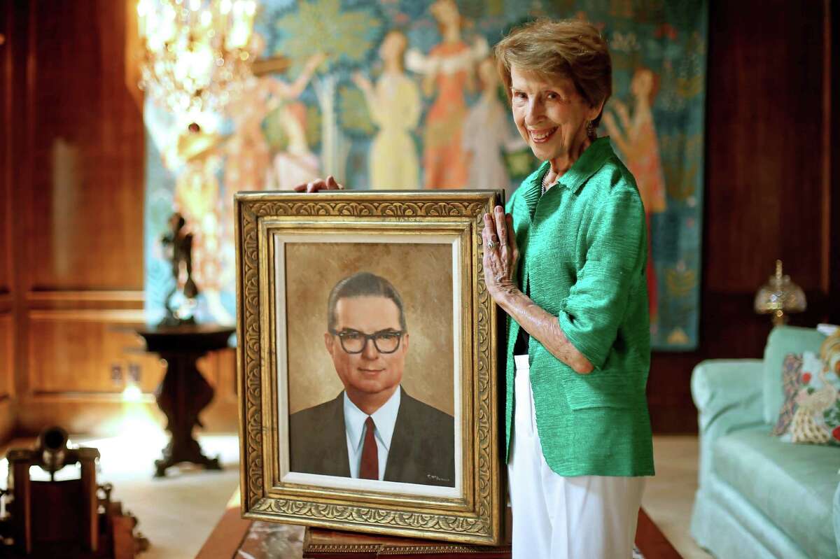 Mary Francis Hofheinz, 87, stands with ﻿a portrait of her late husband, Roy Hofheinz, for whom the University of Houston basketball arena is named﻿﻿. ﻿
