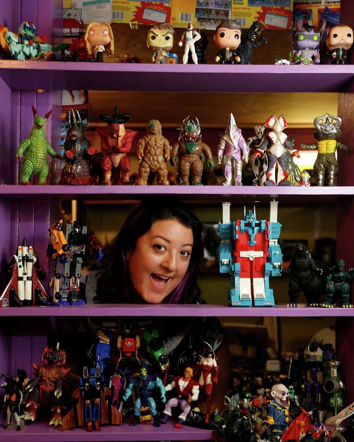 Paulina Gamino, co-owner of Misfit Toys, hopes to attract women, minorities and novice collectors to her business in the Heights. Below: Novelty items, like handcrafted horror figurines, can be found at the shop.﻿
