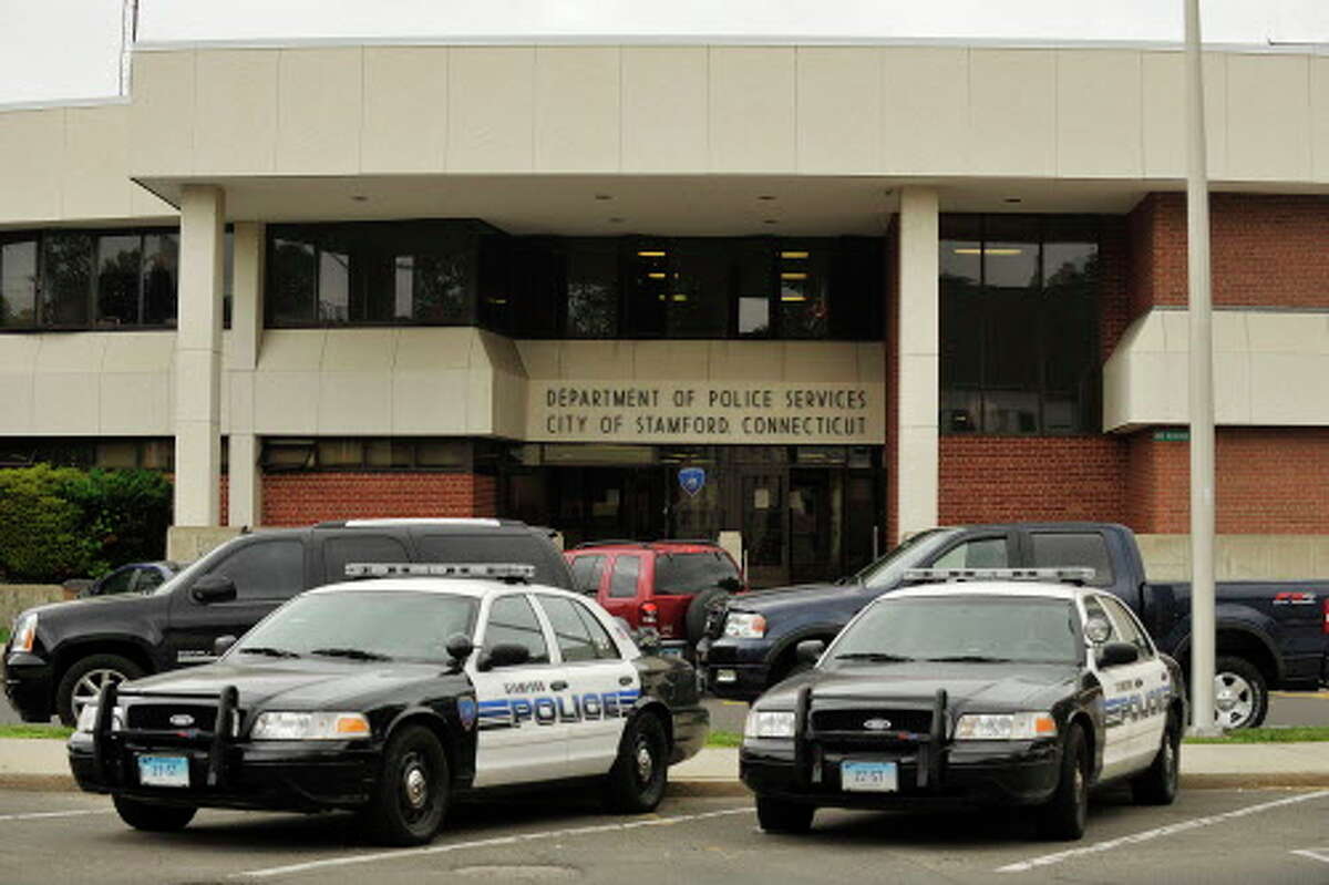 Police cruisers are parked in front of the Stamford police station at 805 Bedford St. The police department is currently running a $271,000 deficit in its overtime account.