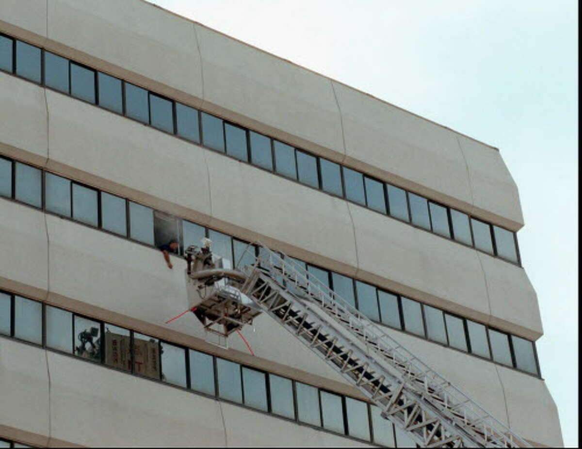 Stamford Fire Department held a high rise drill yesterday morning at the Pitt building on Washington Blvd. The building next to Swiss Bank is scheduled for demolition next month. The Tower ladder approached a 'victim ' hanging out of a smoke filled office on the eighth floor. Jun 14, 97 Tom Ryan/Staff Photo