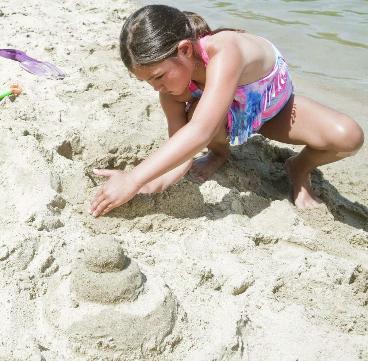 Sara Heinen, 8 of Bethel, works on her sand creation at Martin Park Beach in Ridgefield for the Ridgefield Parks and Rec annual sand castle competition. Monday, July 4, 2016