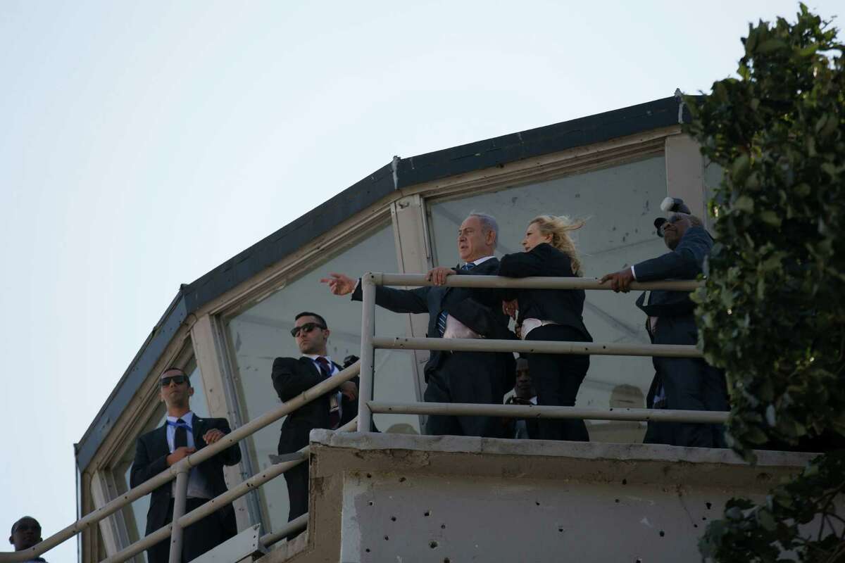 Israeli Prime Minister Benjamin Netanyahu and his wife, Sara, stand on the control tower at the old Entebbe airport﻿ in Uganda﻿.﻿