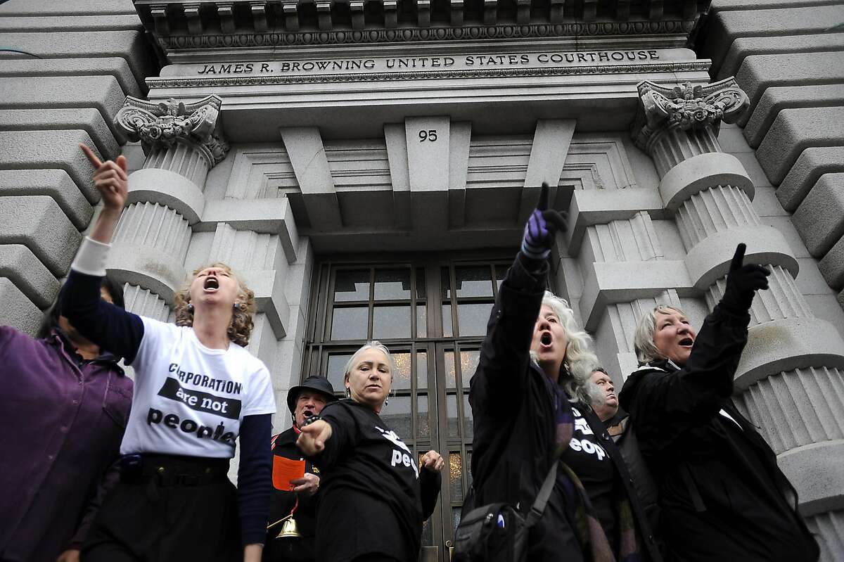 A small flash mob dances on the steps of the court house. In conjunction with Occupy West, Protestors gather in front of the 9th Circuit Court of Appeals in San Francisco to demand a change to the "Citizens United" Supreme Court ruling. Friday January 20th, 2011.