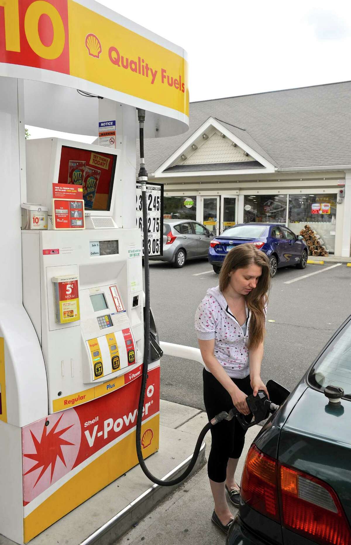 Inna Odarchenko, of Danbury, fills up at the Greenwood Avenue Shell station in Bethel. Gas prices have fallen nationally over the past week. Tuesday, July 5, 2016, in Bethel, Conn.