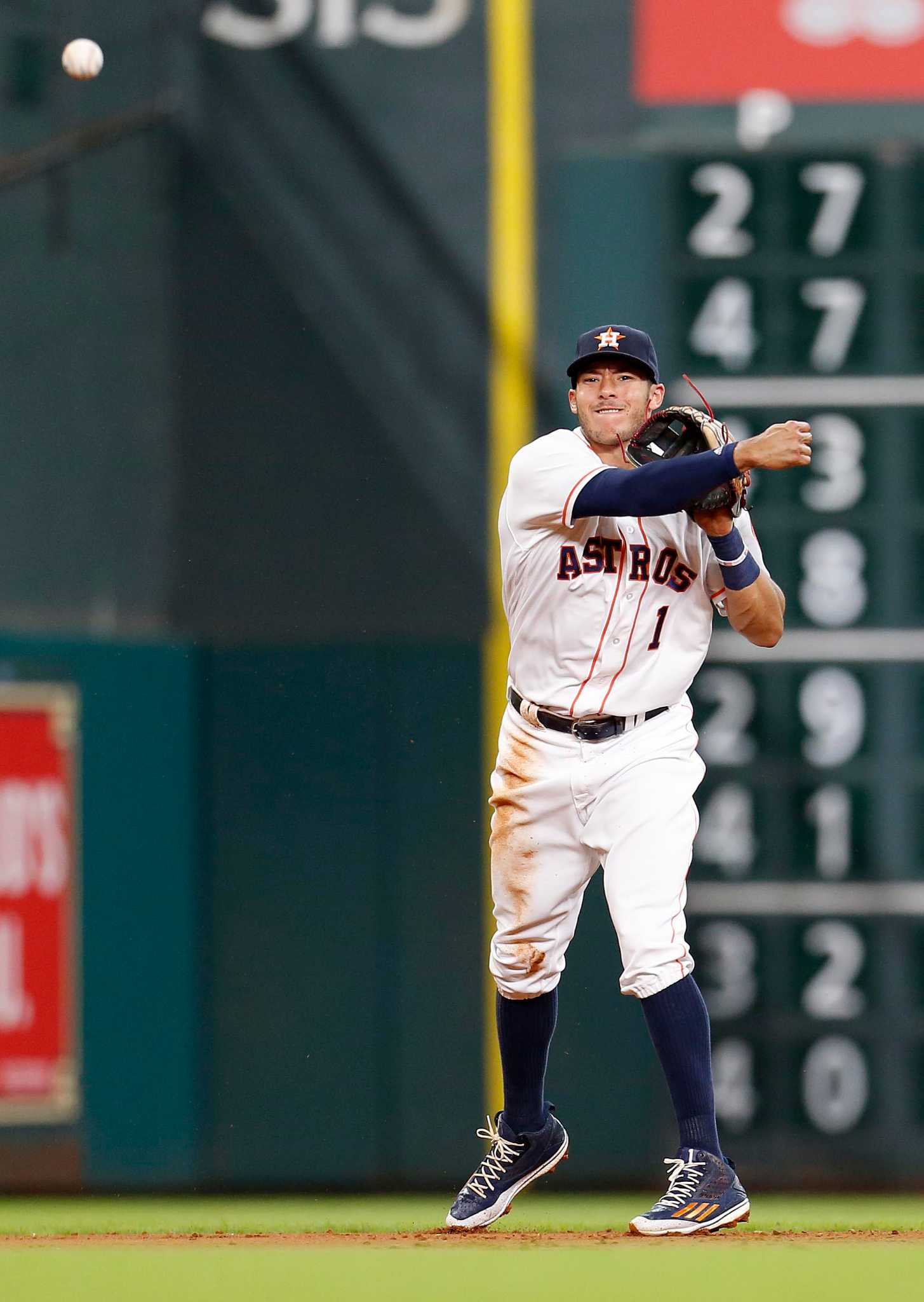 Houston Astros' George Springer (4) celebrates with catcher Evan Gattis  (11) after beating the Los Angeles