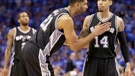 Spurs’ Tim Duncan talks with Danny Green as Green shoots a free throw during second half action of Game 6 in the Western Conference semifinals against the Thunder Thursday on May 12, 2016 at Chesapeake Energy Arena in Oklahoma City.