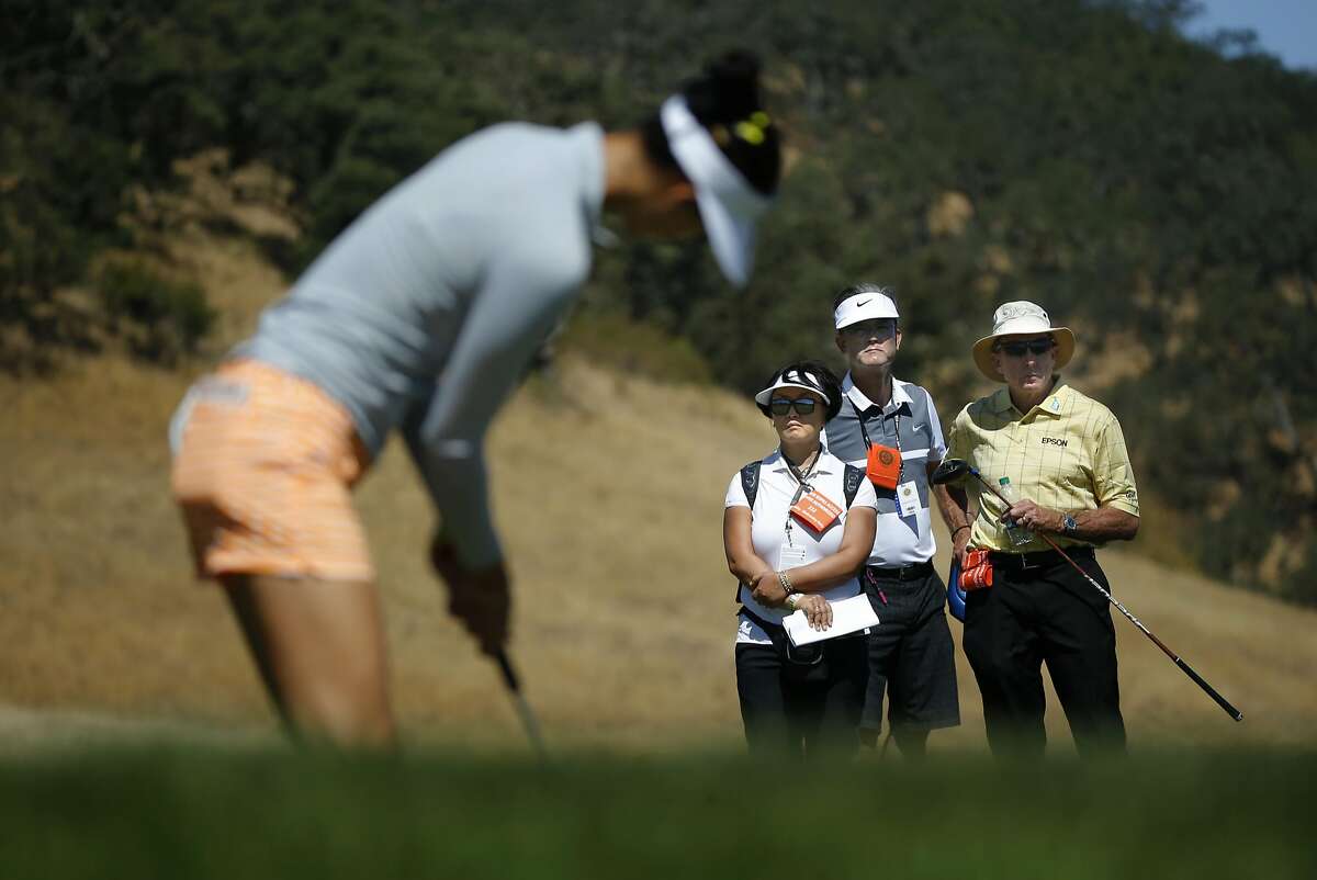 Michelle Wie putting on the 14th hole under the watchful eyes of her parents Bo and B. J. Wie and also golf coach David Leadbetter, (right) during her practice round in preparation for the 2016 US Women's Open Championship at CordeValle in San Martin, California, on Wed. July 6, 2016.