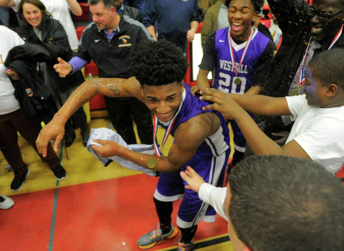 Westhill Parish Rowell is showered with gatoraide after being selected as the tournament MVP. Westhill defeated Danbury 72-61 in an FCIAC basketball championship at Fairfield Warde High School in Fairfield, Conn. on March 3, 2016.