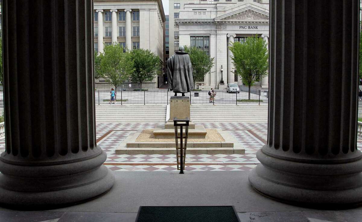 FILE - In this Aug. 17, 2010 file photo, a statue of the Albert Gallatin, the 4th Secretary of the Treasury, stands on the north patio of the US Treasury Building in Washington. Fear and uncertainty about the global economy are leading investors to embrace the relative safety of U.S. government debt and slashing yields to record lows. Interest paid on the 10-year Treasury note reached 1.38 percent late Tuesday, July 5, 2016, just below the previous record set in 2012. (AP Photo/Pablo Martinez Monsivais, File)