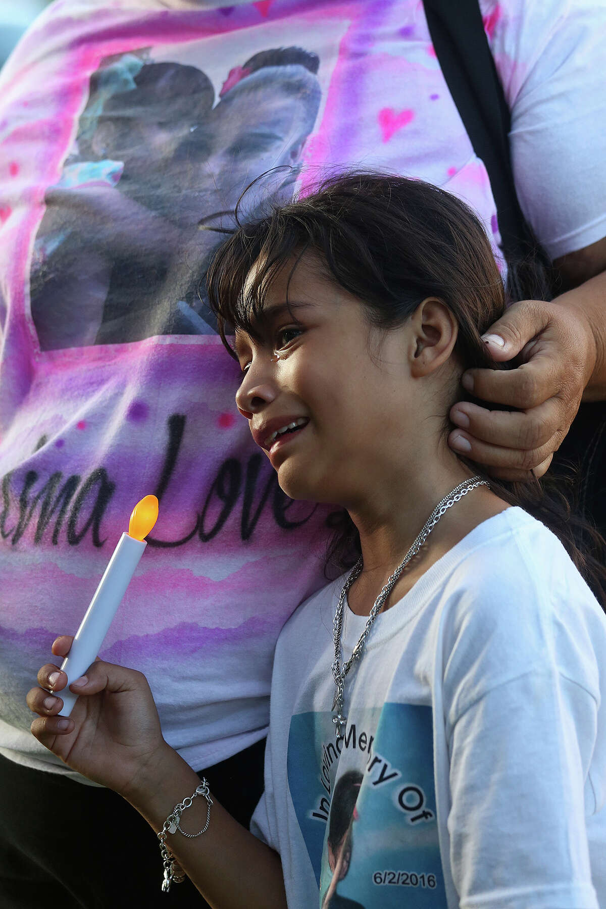 Angela Colunga, 8, cousin of Iris Rodriguez, a 7-year-old who was shot and killed last month on the West Side, is comforted by their grandmother Josephine Juarez during the “Peace Over Violence” prayer vigil before the steps of City Hall.