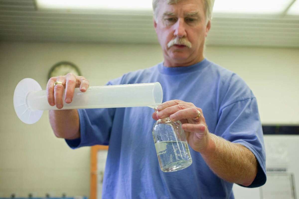 Technician at water treatment plant testing water samples