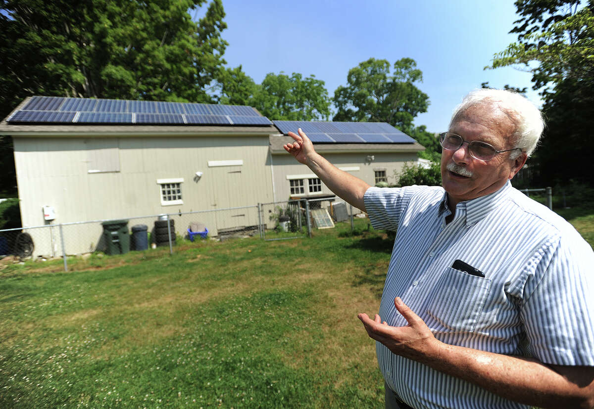 Pieter Moen, a member of Milford's Energy Advisory Board, discusses his solar power system on the garage/barn of his home on High Street in Milford, Conn. on Thursday, July 7, 2016.