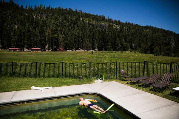Randy Townsend floats in a pool fed by natural hot springs at Drakesbad Guest Ranch in Chester, California, July 1, 2016.