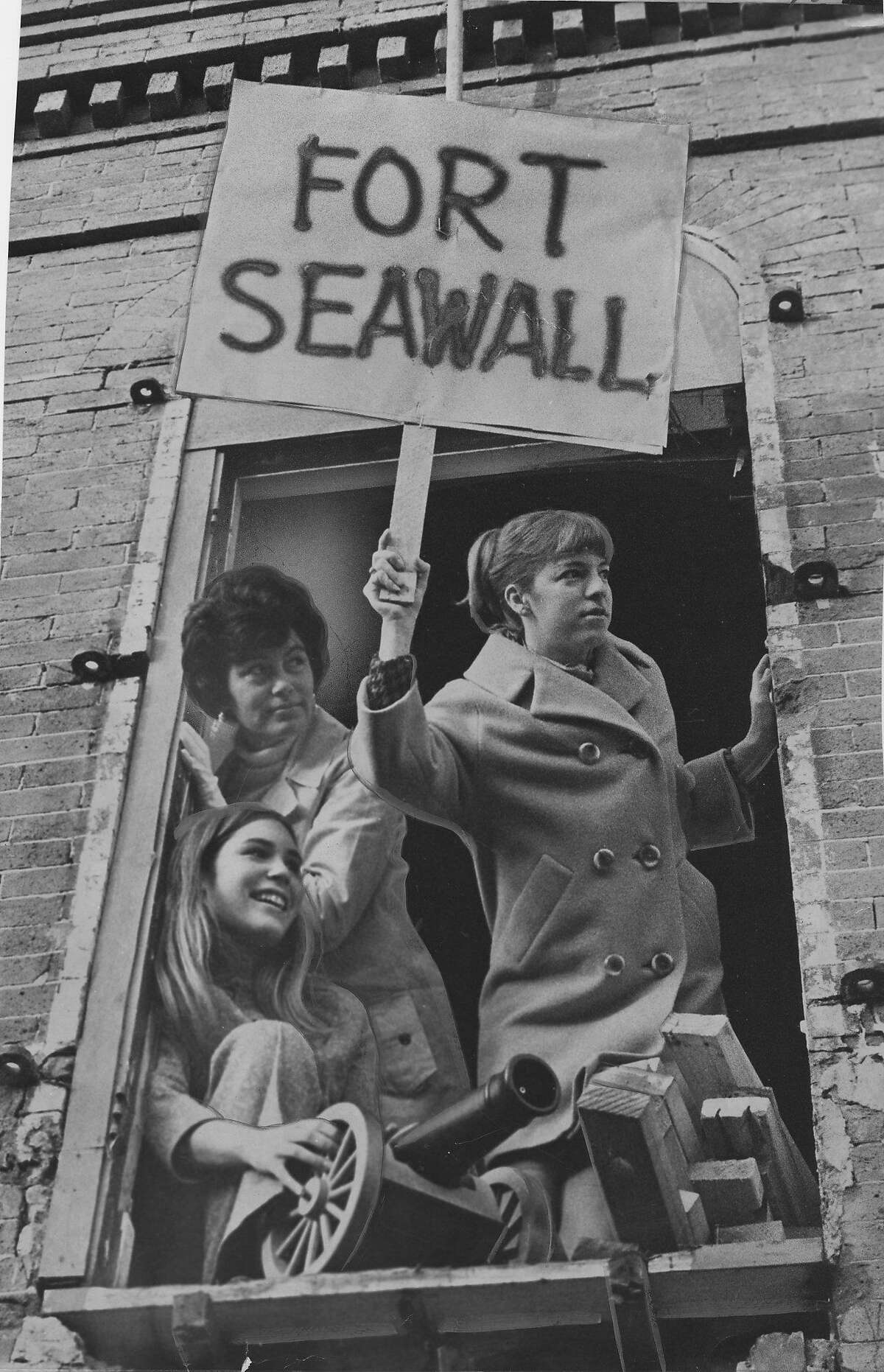 1968年12月30日，自然资源保护主义者占领了这座建筑，海堤仓库被部分拆除，他们称之为海堤堡。橱窗里是特鲁迪·沃什伯恩夫人、乔安妮·沃什伯恩夫人和科拉·米克夫人。照片刊登于1968年12月31日，第8页