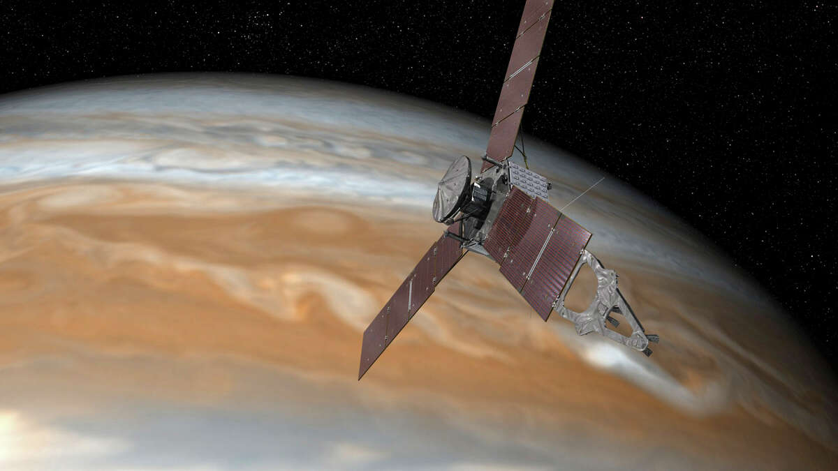 An undated image provided by NASA of a rendering of the Juno spacecraft passing over Jupiter. Ducking through intense belts of violent radiation as it skimmed over the clouds of Jupiter at 130,000 miles per hour, the spacecraft finally clinched its spot on July 4 in the orbit of the solar system’s largest planet.