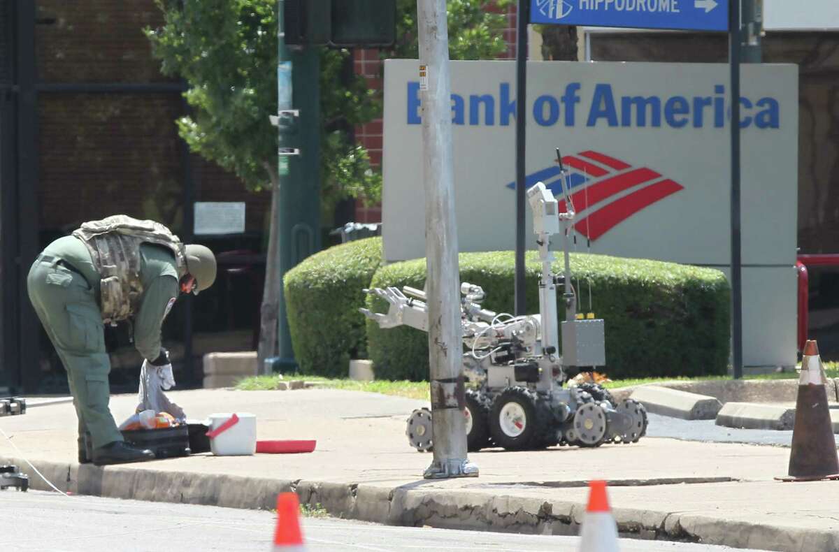 A McLennan County bomb squad member, aided by a robotic device, checks out a suspicious ice chest and luggage last year in Waco. Observers said the Dallas Police Department’s use of a robot to deliver a bomb to kill a suspect carried profound implications.