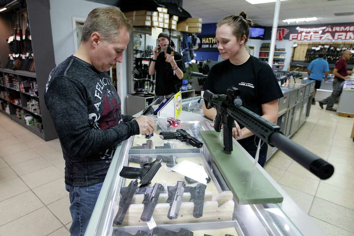 Between Nov. 30, 1998 and December 31, 2014, 1,166,676 requests to buy a firearm were denied.  Johnnie Jackow (left) prepares to buy a new FN Herstal Five Seven 5.7 x 28 gun he purchased with the assistance of sales person Hanna Demorest at Full Armor Gun Range, 11911 Katy Freeway Monday, Dec. 7, 2015, in Houston.