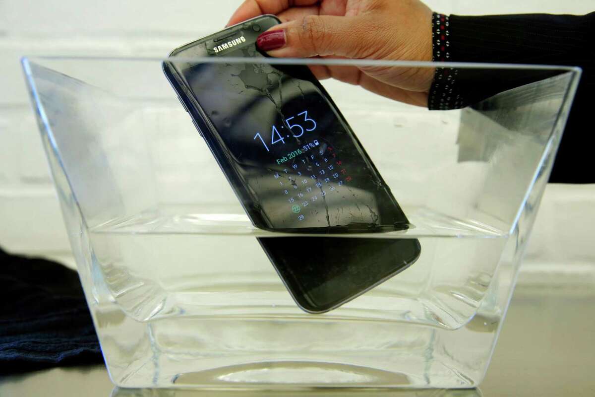A waterproof Samsung Galaxy S7 Edge mobile phone is submerged in water during a preview of Samsung's flagship store, Samsung 837, in New York. Consumer Reports says Samsung's Galaxy S7 Active malfunctions in water despite being marketed as water resistant, though the regular S7 and S7 Edge models passed.