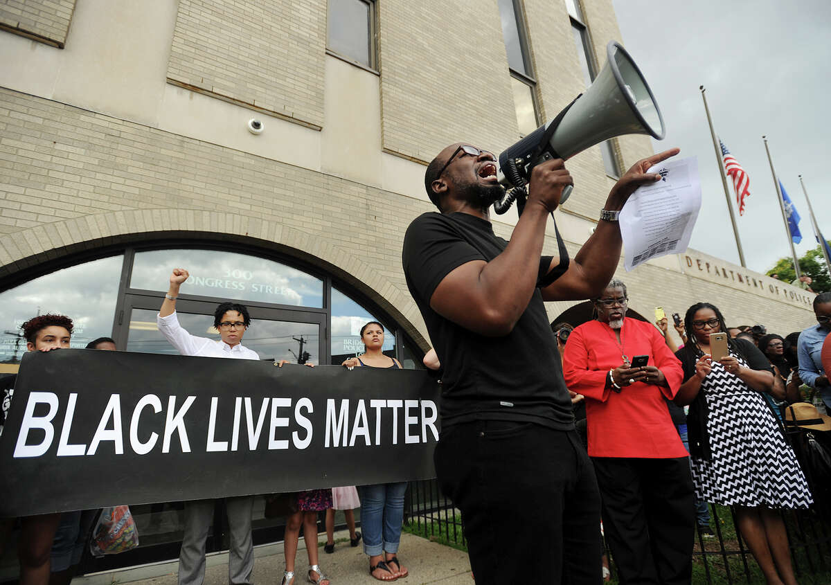 Activist Kevin Muhammad, of Bridgeport, speaks to a large Black Lives Matter protest in front of Police Headquarters on Congress Street in Bridgeport, Conn. on Sunday, July 10, 2016. Several hundred protesters marched from Mount Aery Baptist Church on Frank Street to protest last week's killing of black men by police officers in Louisiana and Minnesota.