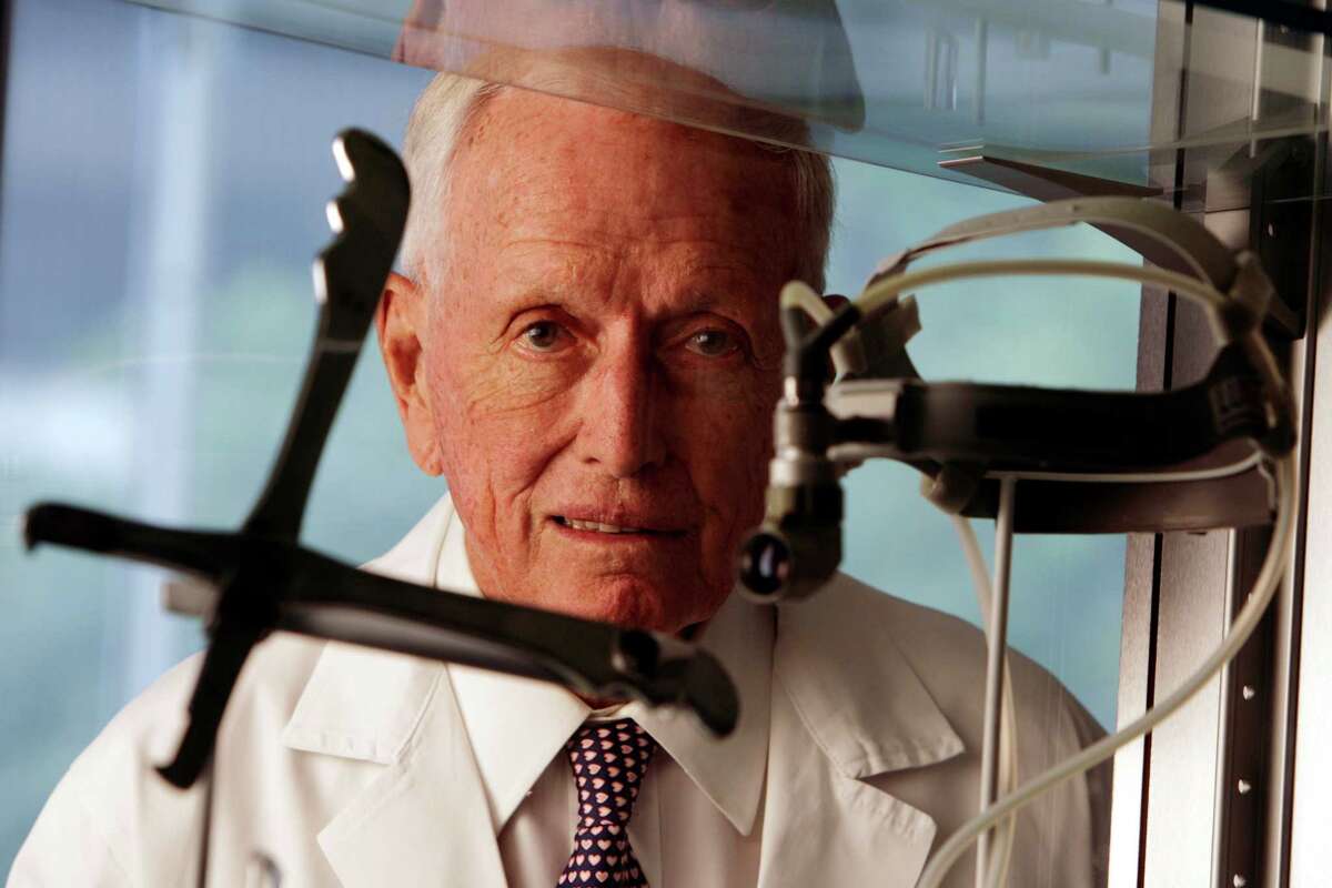 Dr. Denton Cooley for Q&A, framed between two of his inventions, a sternotomy knife used to open the chest during the earliest open heart operations, and a head lamp July 23, 2008, in Houston, TX. Wednesday, July 23, 2008, in Houston. ( Eric Kayne / Chronicle )