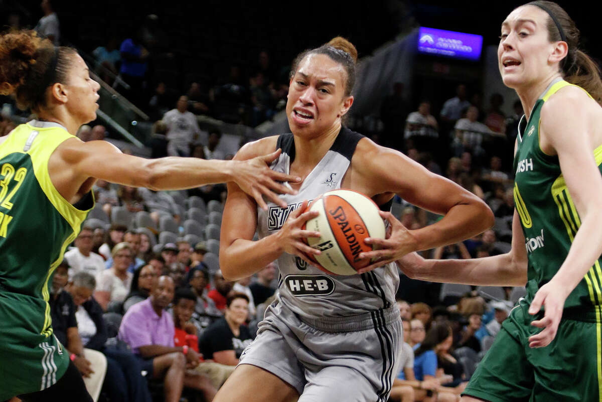 Stars’ Dearica Hamby drives between the Seattle Storm’s Alysha Clark and (left) and Breanna Stewart on July 8, 2016, in San Antonio.