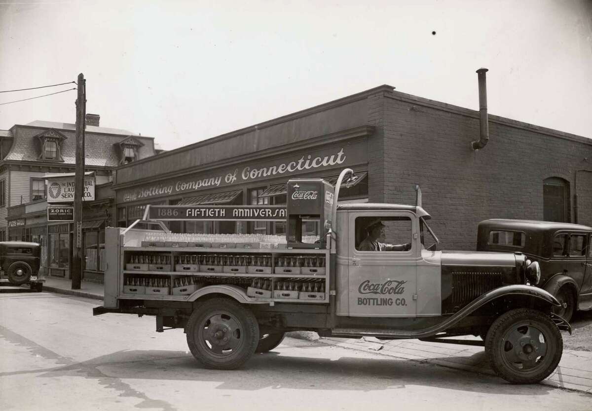 A truck laden with bottles leaves the Coca-Cola Bottling Company of Connecticut premises on the 50th anniversary of the product, 1936.
