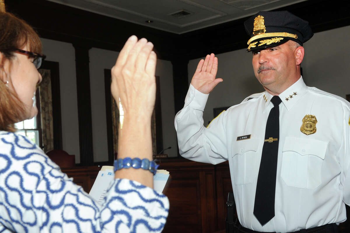 Joseph McNeil is sworn in as Stratford's new Chief of Police during a ceremony at Town Hall in Stratford, Conn. July 11, 2016. McNeil takes the oath from Town Clerk Susan Pawluk.