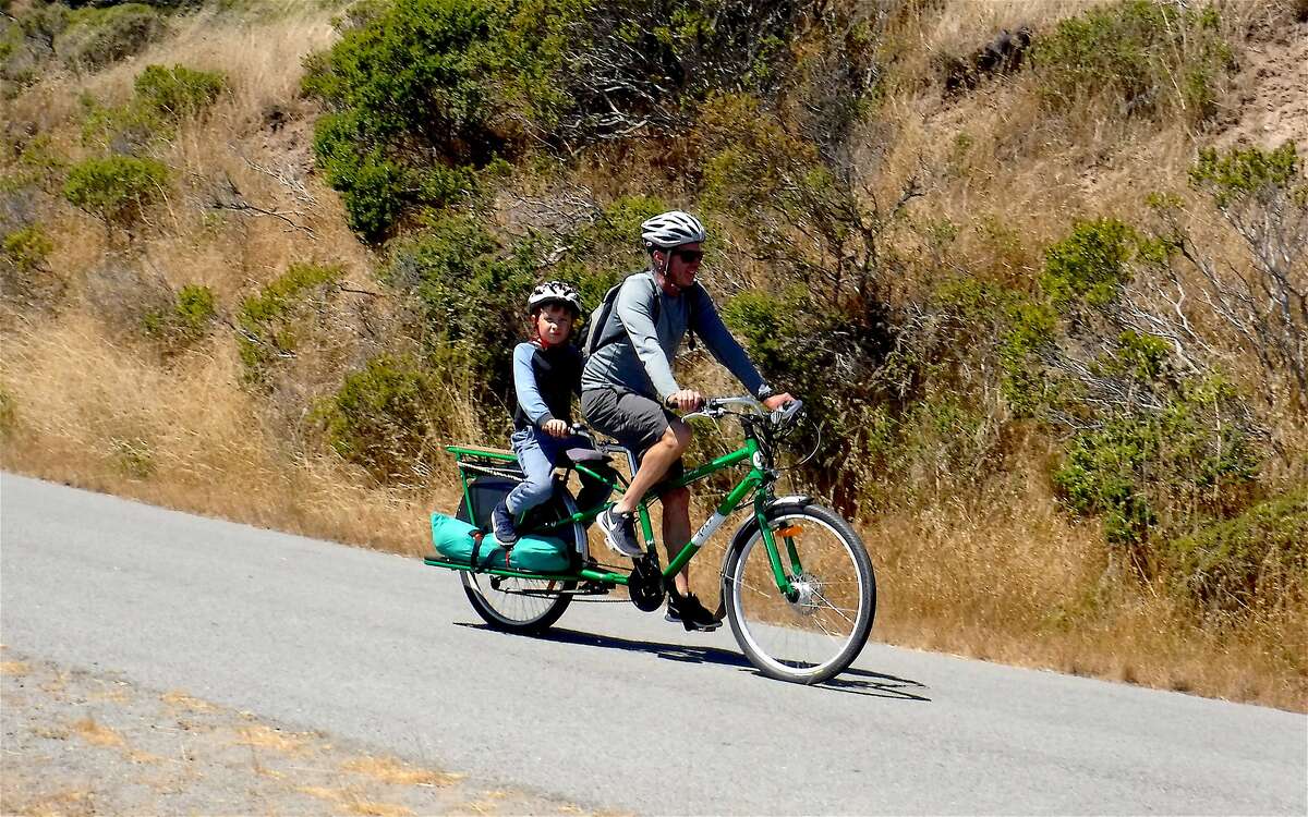 Father &son bike the 5-mile Perimeter Road at Angel Island State Park, the most popular bike trail in the Bay Area