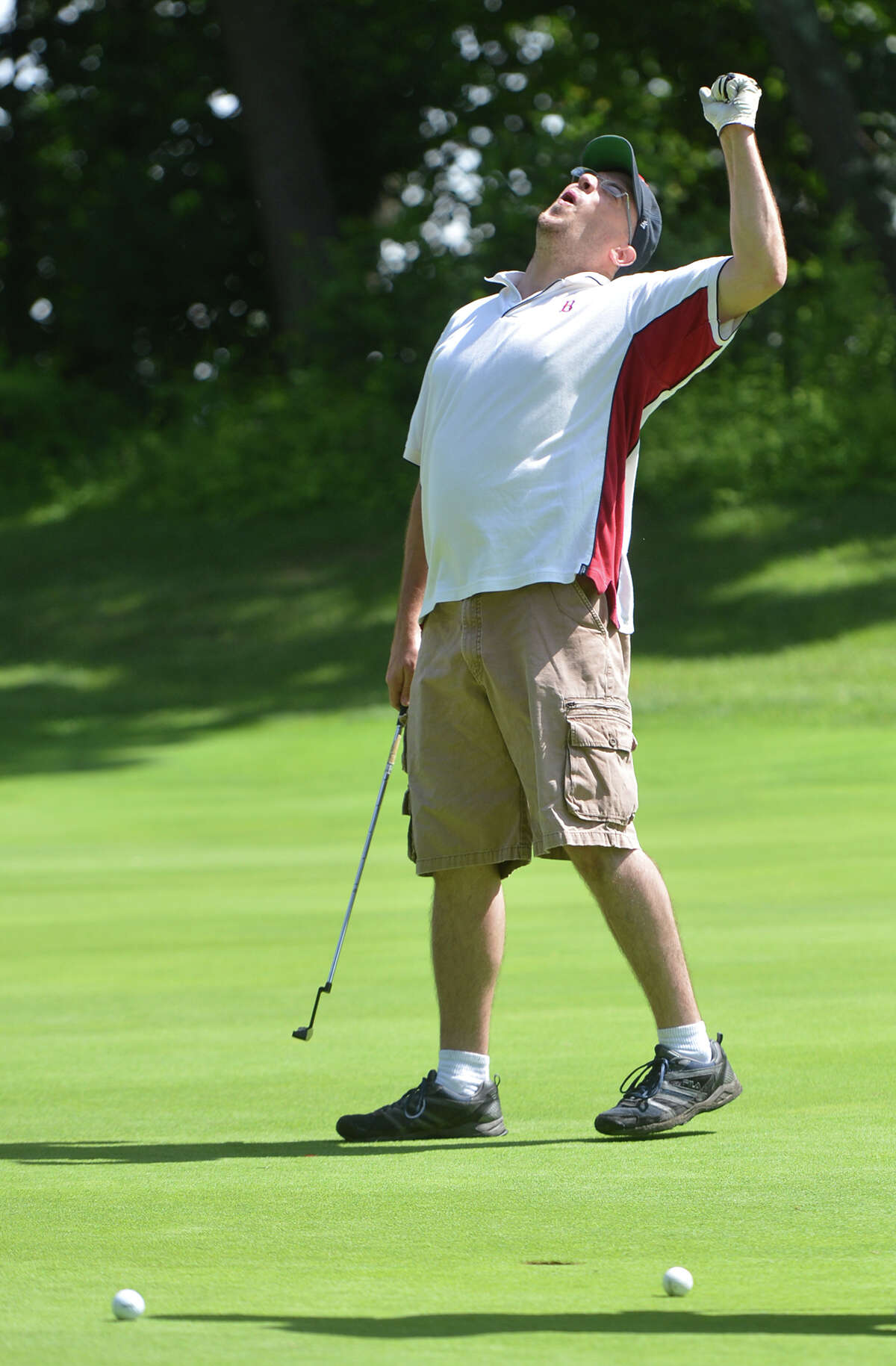 Matt Copeland celebrates sinking a put on the 4th hole at Oak Hills Public Golf Course during Brien McMahon High School's Alumni Association 11th annual golf tournament and fundraiser on Monday July 11 2016 in Norwalk Conn.