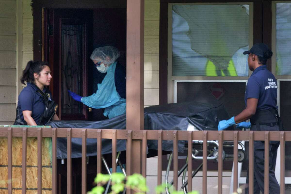 A homicide victim is taken from a home in the 2800 block of Dover, as police investigate the scene, on Monday﻿ in Houston.﻿