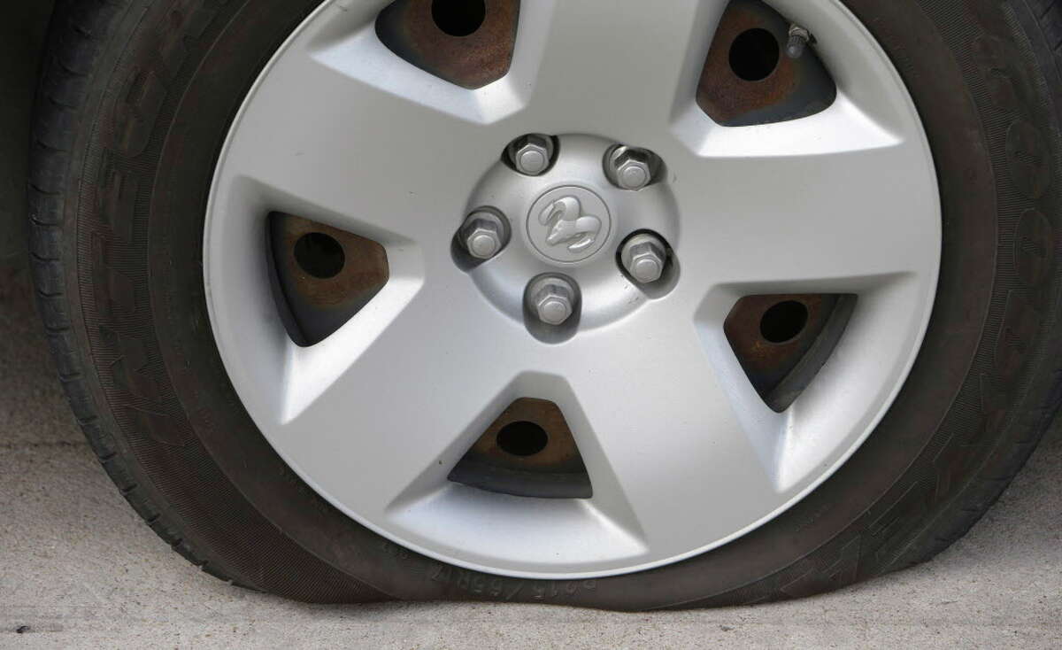A flat tire on a test car is shown after running over the Night Hawk Spike Deployment System device during testing at the driving track of the Houston Police Academy L. D. Morrison Sr. Memorial Center, Tuesday, July 12, 2016, in Houston. NightHawk tire deflation device is a remotely deployed and retracting vehicle pursuit termination system.